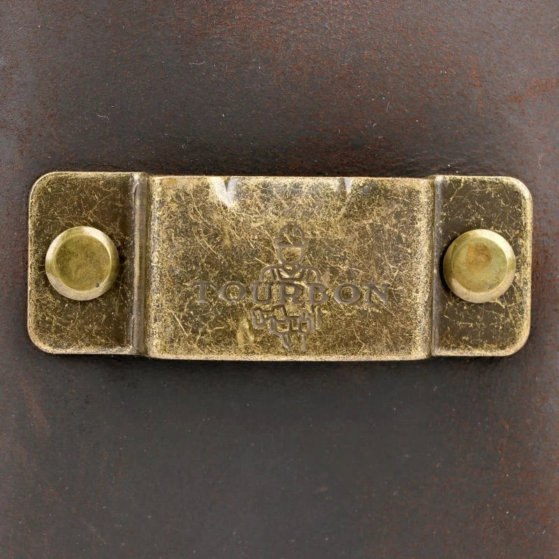 Brass tape measure clip on a vintage leather tool holster Brass tape measure clip on a vintage leather tool holster